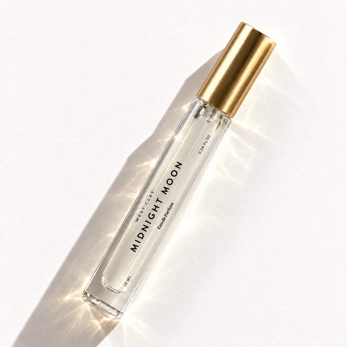 Midnight Moon Eau de Parfum by West Clay, 10 mL travel size flash flat lay studio photo