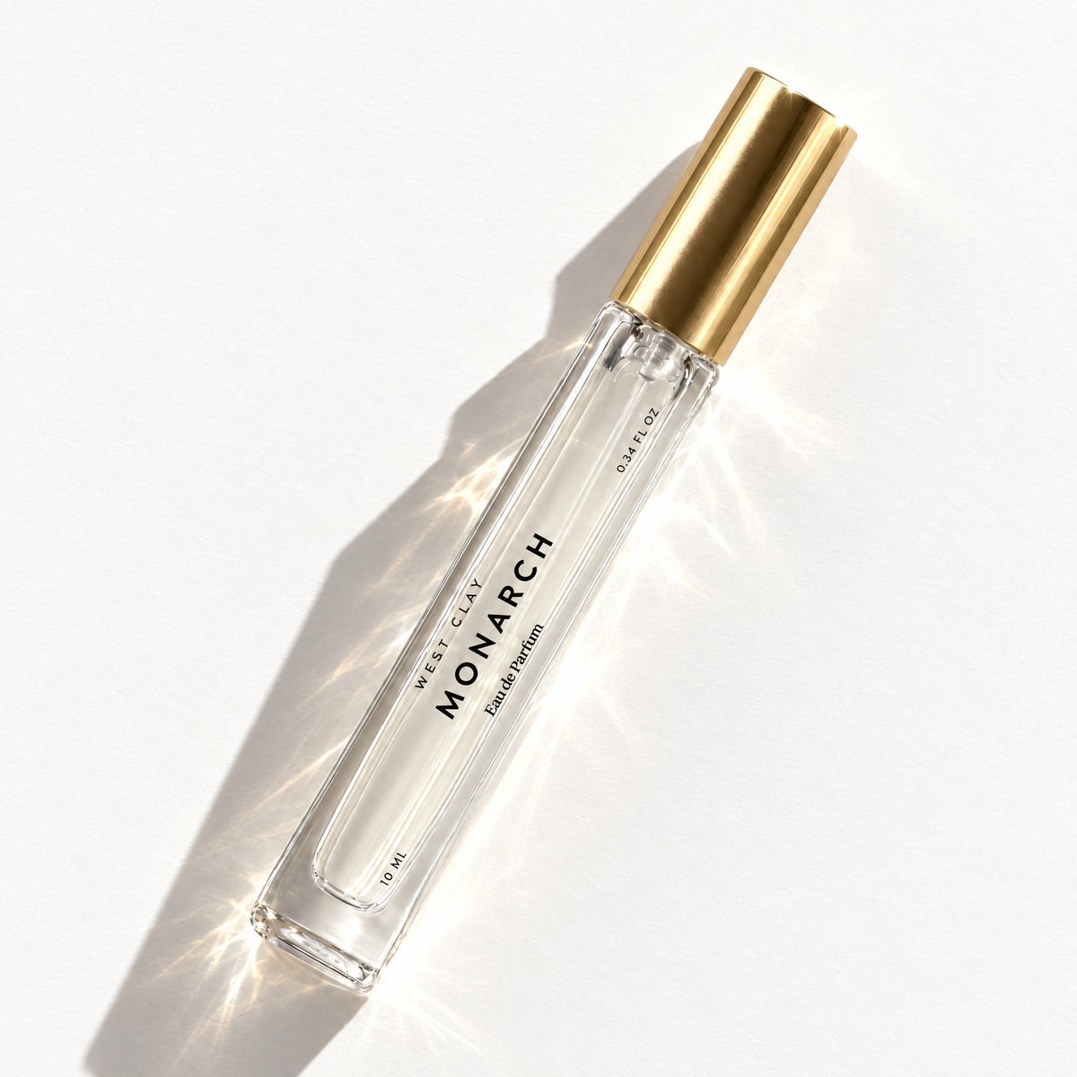 Monarch Eau de Parfum by West Clay, 10 mL travel size flash flat lay studio photo