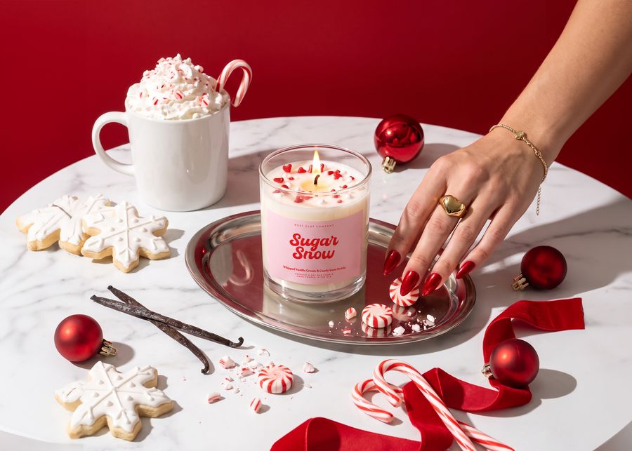Sugar Snow candle in a gift box with a candy cane, a cocoa mug and a red ornament